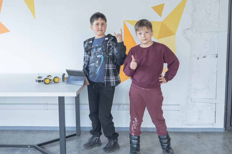 Child interacting with a robot in class